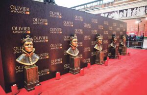 This photo shows a row of Olivier Awards which will be awarded to opera productions and artists.