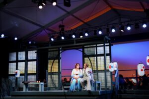 Princeton Festival Madama Butterfly 2026 This photo is a production still featuring Victor Starsky and Toni Marie Palmertree in discussion.