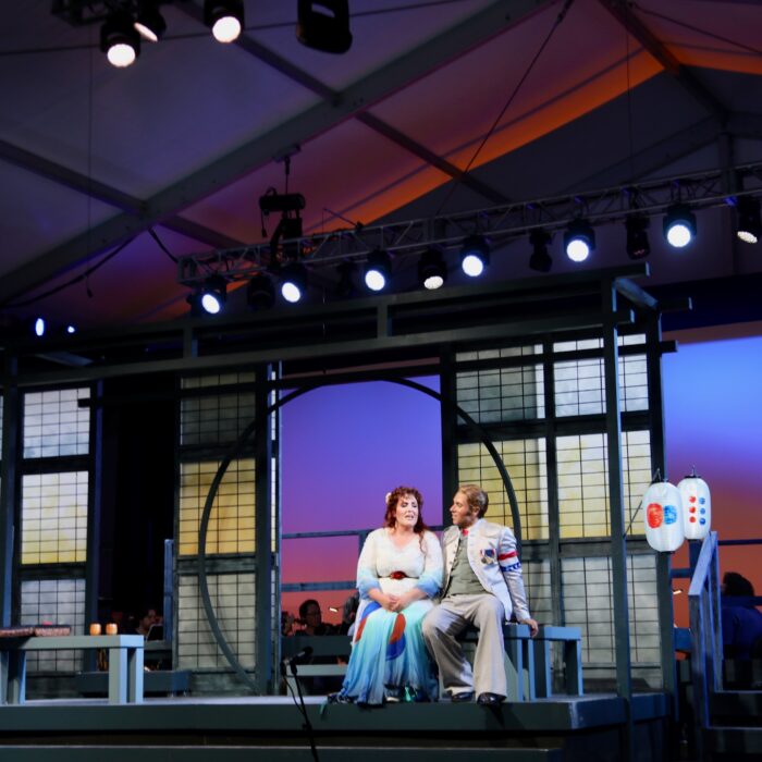 Princeton Festival Madama Butterfly 2026 This photo is a production still featuring Victor Starsky and Toni Marie Palmertree in discussion.
